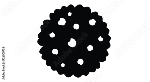 A dark circular cookie with holes depicted as a silhouette