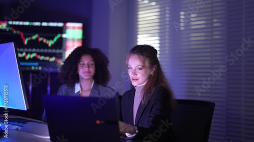 Senior software developers debugging complex backend cloud infrastructure code. Female data science engineers reviewing predictive AI algorithms on digital tablet and monitor.