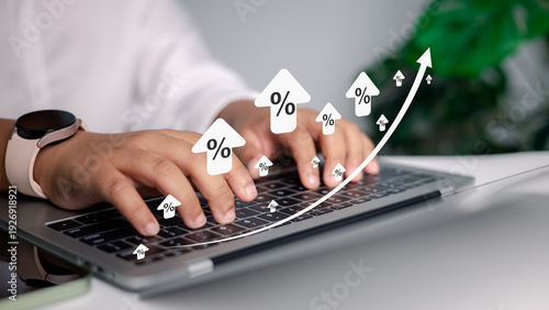 Fotografía Person using laptop with rising percentage icons and growth arrow