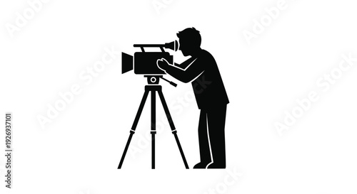 A cameraman operating a movie camera on a tripod silhouette