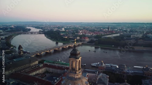 A circular aerial shoot of dome of the Frauenkirche with Dresden's Old Town and the River Elbe behind in Dresden in Germany at dawn