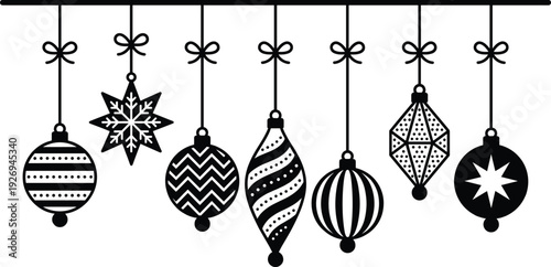 Black and white Christmas ornaments hanging from horizontal bar with bows, featuring spherical, teardrop, and star shapes decorated with festive holiday patterns