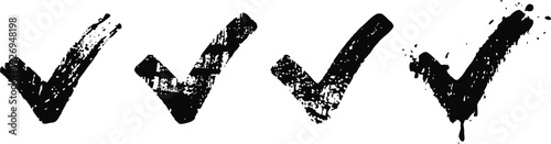 Four black grunge check marks in a row on white background, hand drawn ticks for approval or verification
