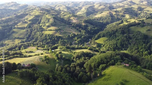 4K Aerial Drone Flight Over Green Hills with Houses and Forest in Transylvania, Romania, Peaceful Countryside