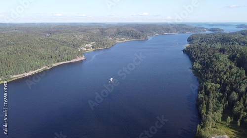 Wallpaper Mural 4K Aerial Drone Shot of White Boat Sailing on Dark Blue River Surrounded by Green Forests and Red Houses in Karelia Torontodigital.ca