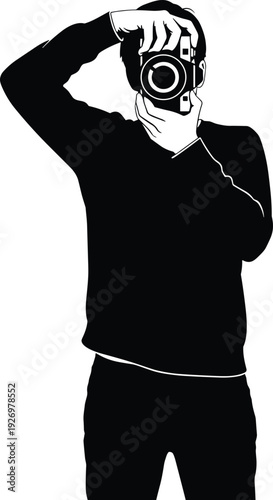 Man in black hoodie holding futuristic mask over head