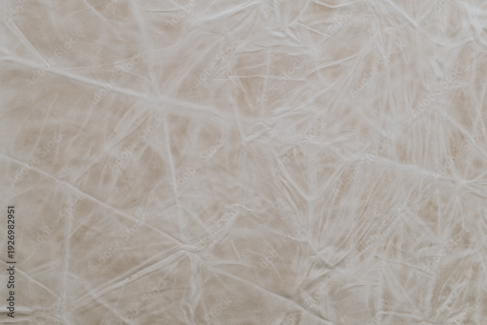 Obraz premium Wrinkled fabric texture shows light colors and patterns under natural light in a close-up view during daytime