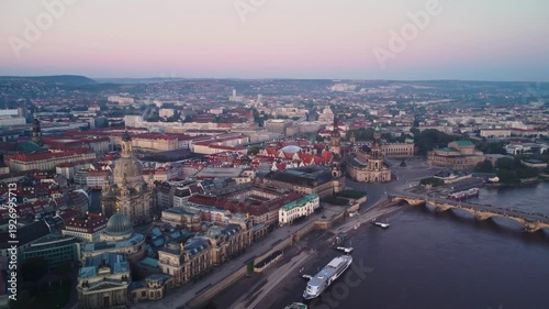 A pushing back aerial shoot of the Frauenkirche with Dresden's Old Town  behind in Dresden in Germany at dawn