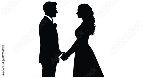 A newlywed couple stands closely facing each other and holding hands presented as a silhouette high quality professional