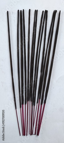 Incense Sticks Arranged Neatly on a Plain Background for Use in Rituals or Aromatherapy Purposes