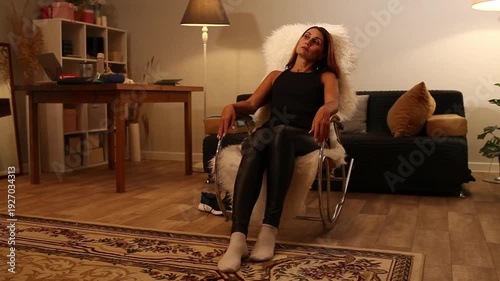 woman gently rocks in rocking chair and talks a little