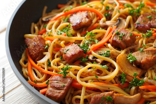 Delicious Stir Fry Noodles with Meat and Vegetables in a Pan.