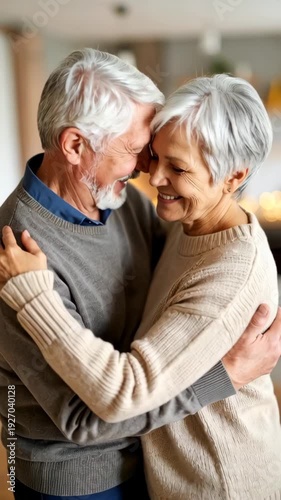 Elderly couple embracing indoors, sharing a loving moment with smiles