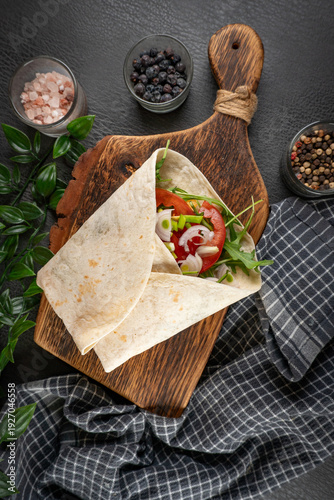 Tortilla wraps with vegetables and chicken on a plate.
