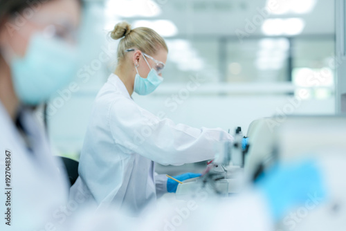 Pharmaceutical quality control analyst validating equipment sterility protocols. R&D chemist monitoring autoclave sterilization cycle for biopharmaceutical compliance.