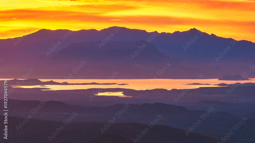 Obraz premium Aerial Sunrise Over Nevada Desert Mountains and Reflective Water Golden Hour