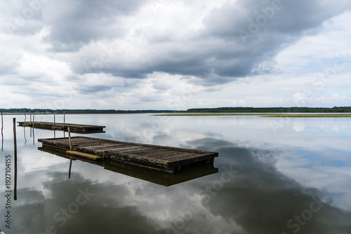 Wallpaper Mural Lake of Soustons reflecting a cloudy sky and wooden docks Torontodigital.ca