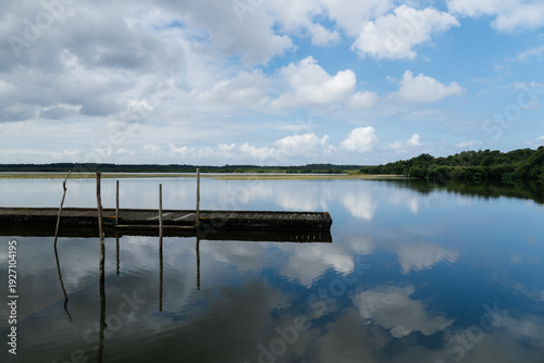 Wallpaper Mural Lake of Soustons reflecting a cloudy sky and wooden docks Torontodigital.ca