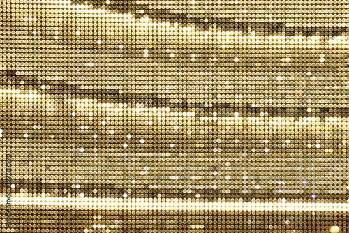 Shiny glittering gold sequin mesh fabric texture background