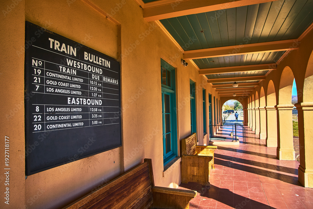Fototapeta premium Kelso Visitors Center Train Bulletin Board and Sunlit Arched Walkway Mojave
