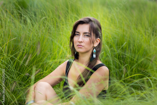 young woman lying on grass