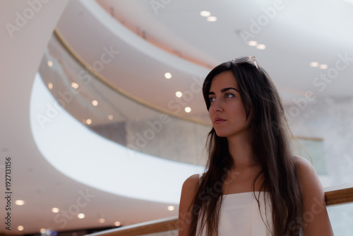 young girl against the backdrop of a beautiful ceiling in a shopping centre