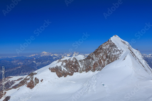 Mountain glacier panorama with summit Lyskamm (foreground right) and Mont Blanc massif (background left) in Pennine Alps, Italy