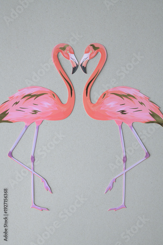 two paper flamingos on blank millboard