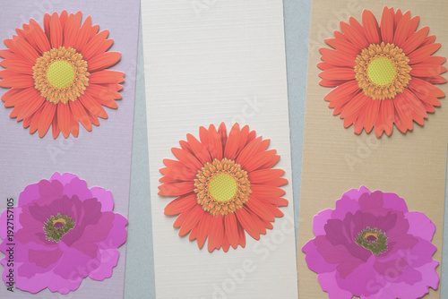 die-cut paper daisies and pink flowers on stripes of paper