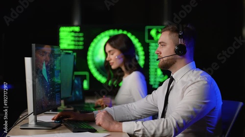 Call center operators working in a control room