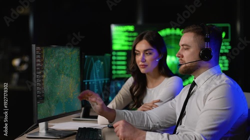 Air traffic controllers monitoring flight paths in a control center