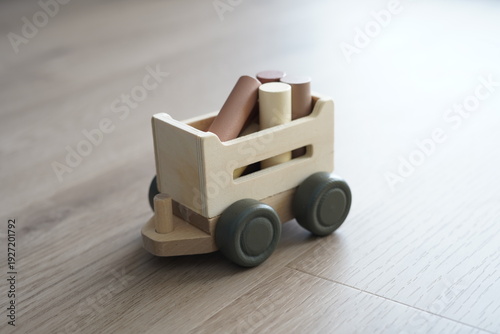 A piece of children's wooden toy. It's a wood cart.