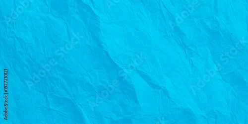 vibrant cyan crumpled paper texture background, bright blue wrinkled paper surface with folds and creases