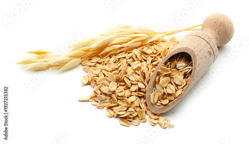 Oat flakes in wooden scoop and florets isolated on white