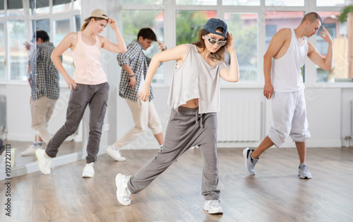 Canvas Print During hip hop dance lesson, girl leads, conducts classes, teaches students to c