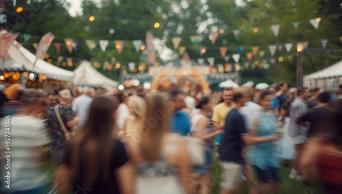 Abstract blurred figures at a vintage outdoor festival transitioning from day to night in a park. Theme: celebration