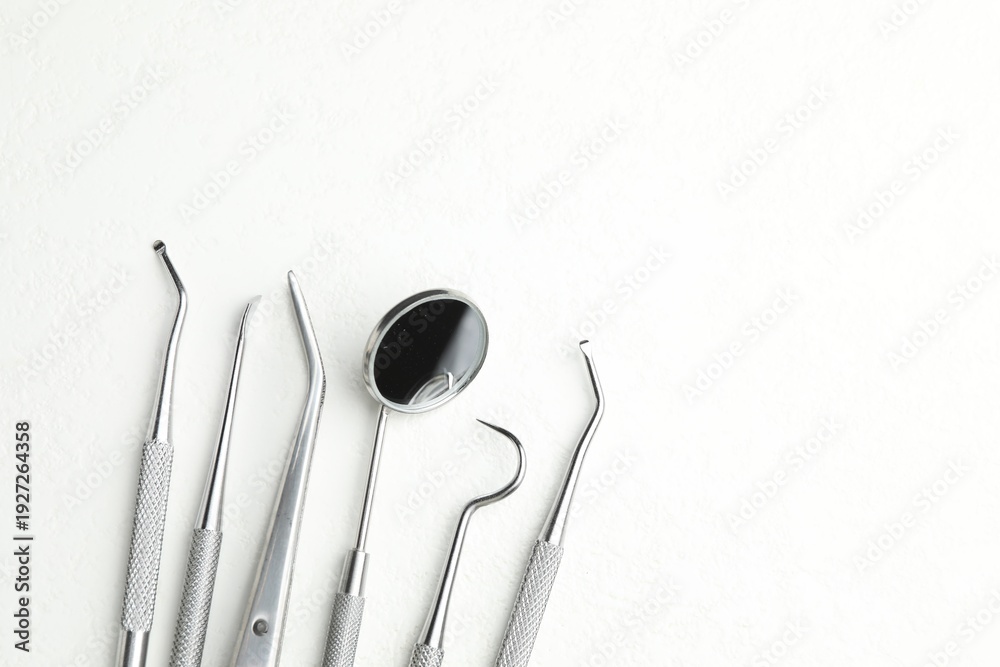 Fototapeta premium Many different dental tools on white table, flat lay. Space for text