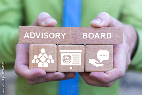 Concept of advisory board. Financial advisory services. Advisory committee. Change advisory board. Business person holding wooden blocks with icons sees the text ADVISORY BOARD.