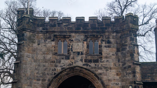Whalley Abbey gatehouse. The top of the old stone gate on a cloudy day