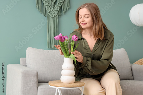 Young woman with tulips sit...