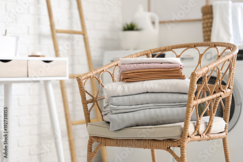 Armchair with stack of clea...