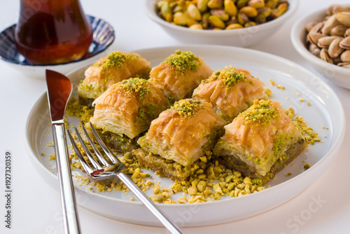 Traditional Turkish Pastry Dessert Baklava designed with tea and pistachio nuts