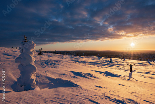 Bild auf Leinwand Hiking to the summit of Mount Kiilopää during a spectacular arctic sunset in Finnish Lapland