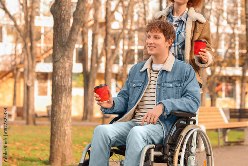 Young man in wheelchair and...