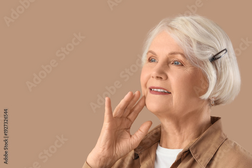 Senior woman on beige backg...