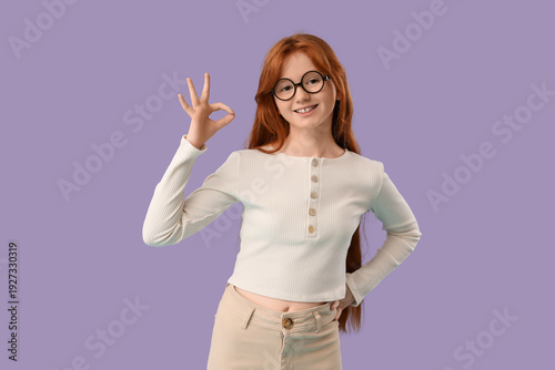 Teenage redhead girl showin...