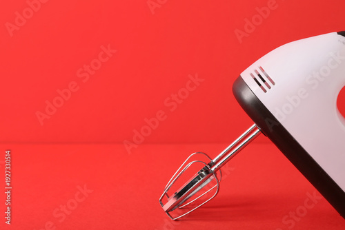Electric mixer on red backg...