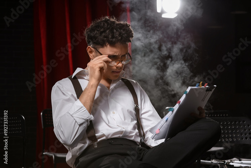 Male screenwriter reading s...