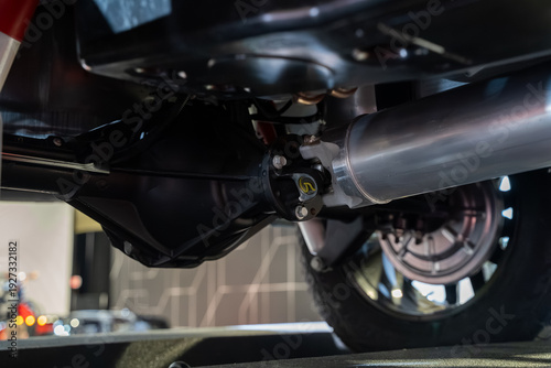 Tableau sur toile Close up of car driveshaft and rear axle underneath vehicle