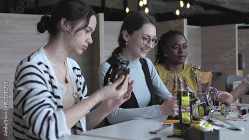teacher teaches students about creating and designing robots in classroom